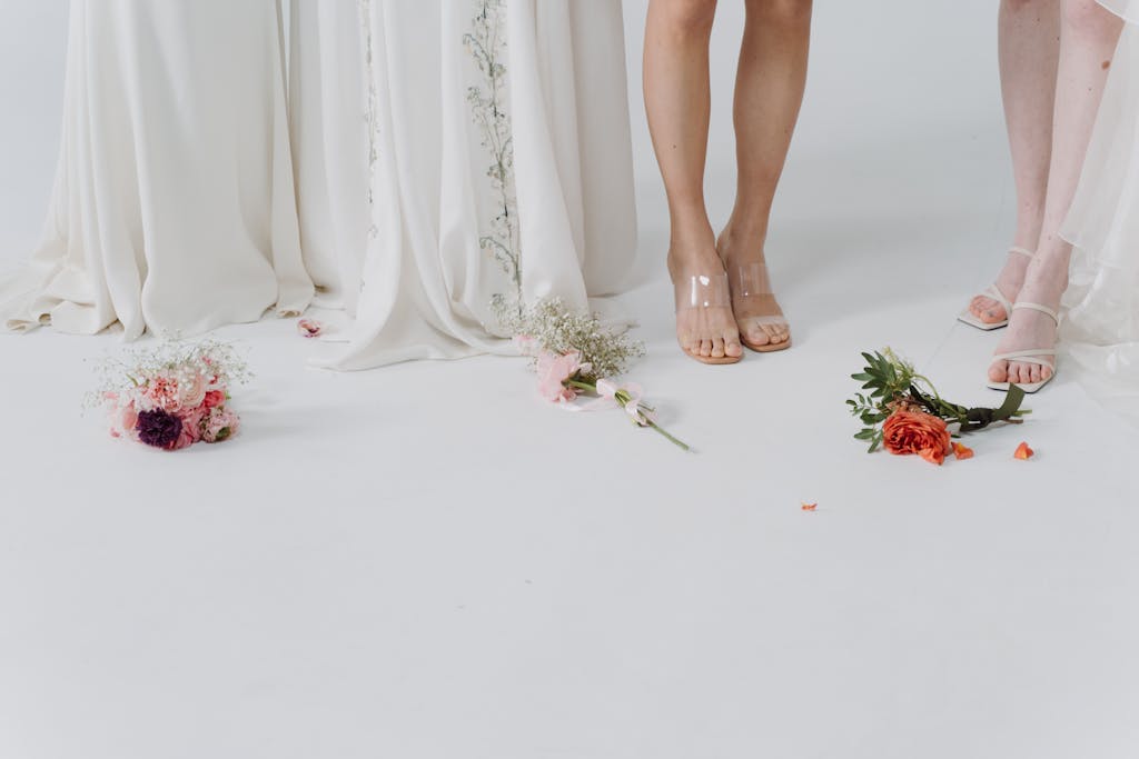 Elegant wedding dresses and scattered bouquets create a romantic vibe.